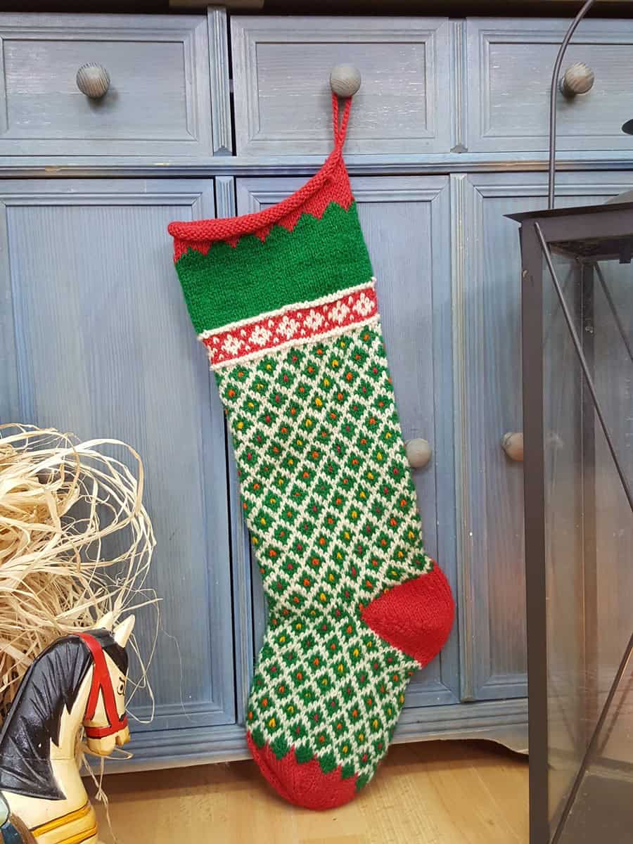 Green and red hand knit personalized holiday stockings with diamond lattice and scalloped cuff, artisan made.