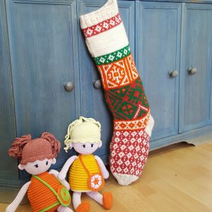 Fair-trade Christmas stocking featuring customizable name area and mixed knit motifs.