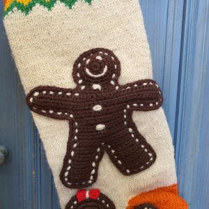 Close-up of gingerbread man appliqué on hand-knit stocking