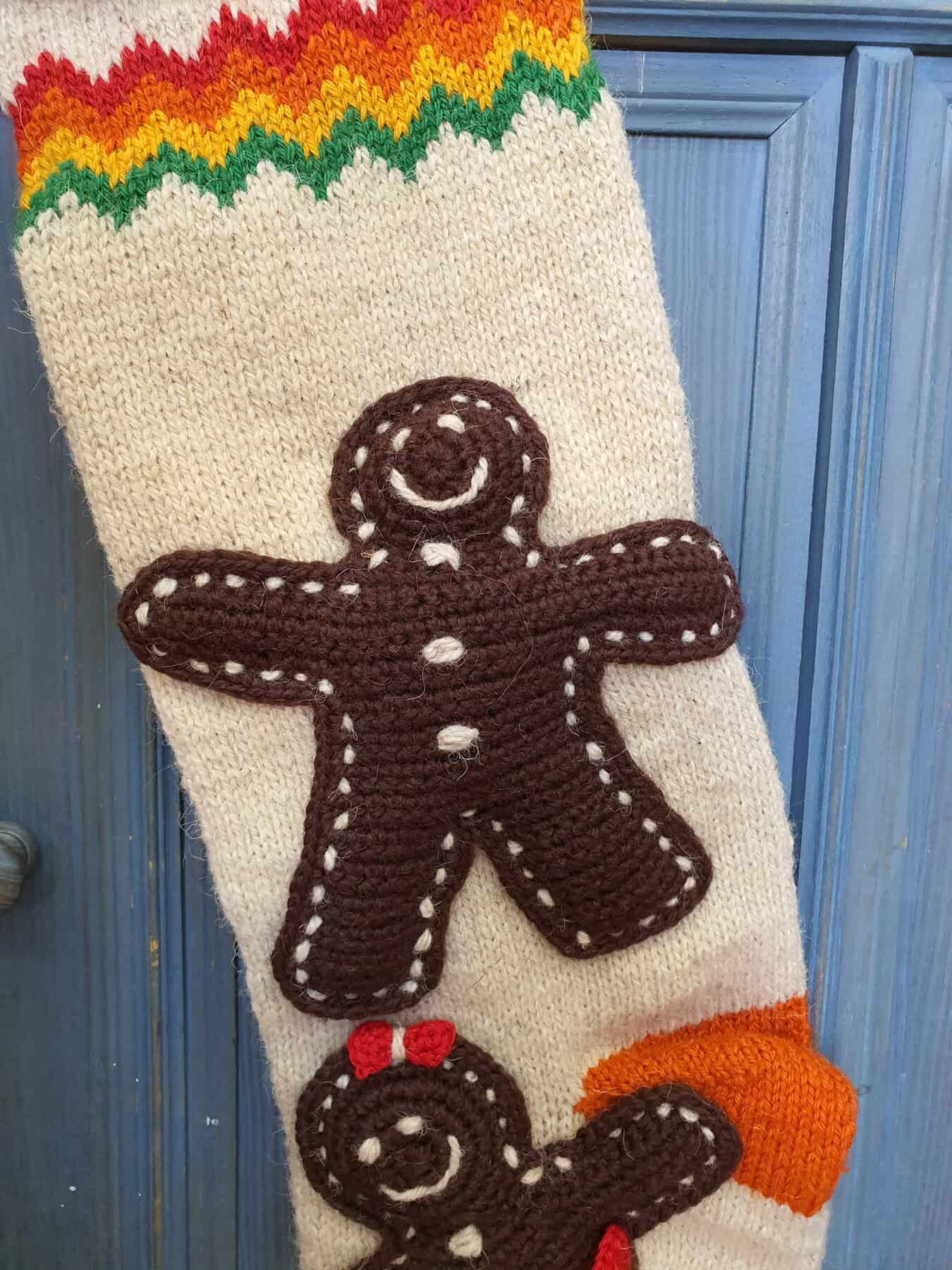Close-up of gingerbread man appliqué on hand-knit stocking
