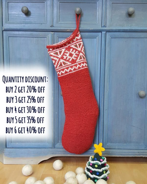 Artisan jacquard knit Christmas stocking hanging on a mantel, double-sided pattern
