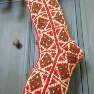 Close-up of jacquard pattern detail on red-and-white stocking