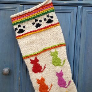 Black paw print crochet design at top of cat-themed Christmas stocking for your holiday décor