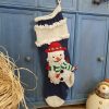 Hand-knit blue Christmas stocking with snowmen appliqué, personalized name on cuff
