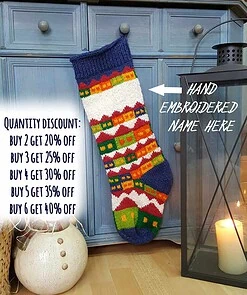 Hand-knitted Christmas stocking with snowy village holiday scene