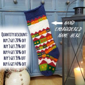 Hand-knitted Christmas stocking with snowy village holiday scene