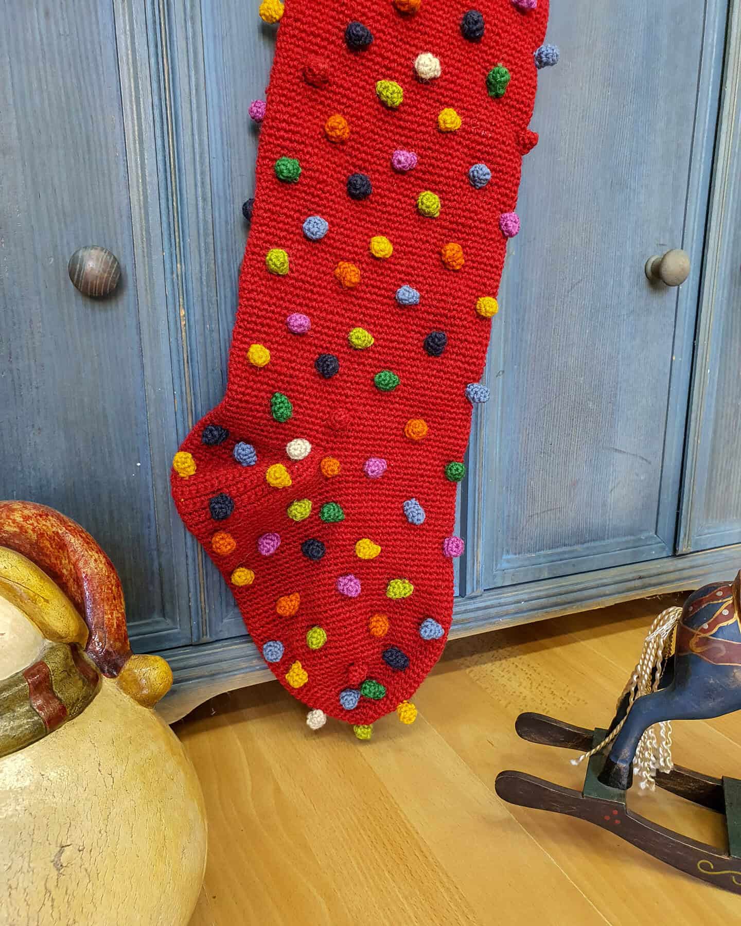Detailed crochet stitch pattern on a red fair trade Christmas stocking