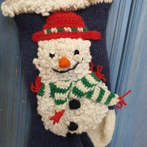 Close-up of snowman appliqué on hand-knit personalized Christmas stocking