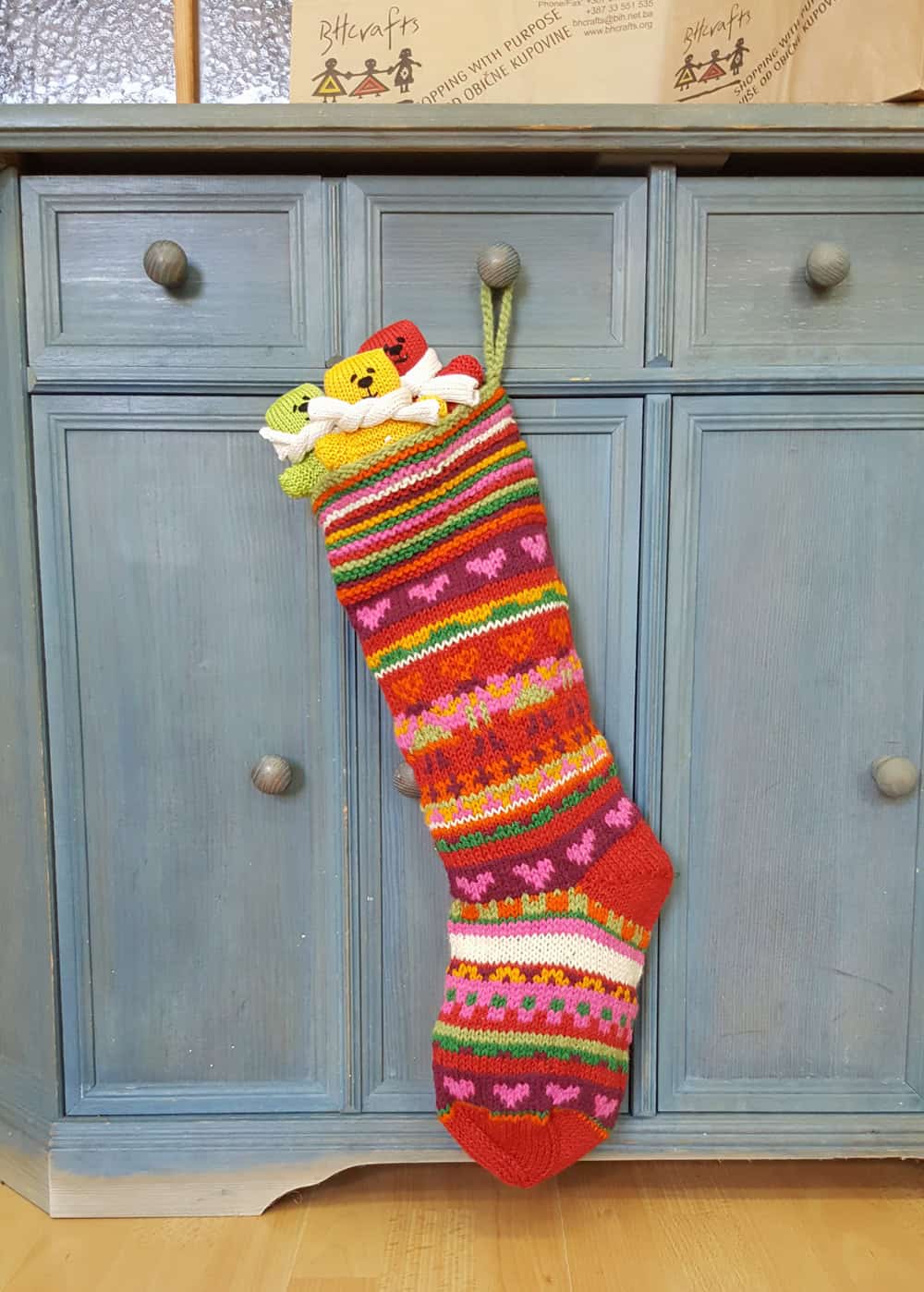 Festive knit stocking with hearts and stripes, fair-trade holiday décor