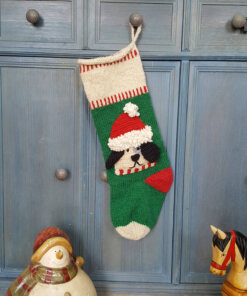Personalized dog stocking hanging beside a lantern in a cozy scene