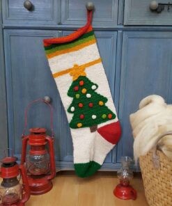 Hand-knitted Christmas stocking with green tree design, colorful ornaments, and striped cuff, hanging.