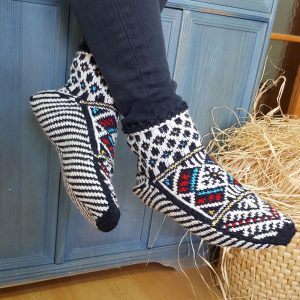 Hand knit wool slipper socks with traditional Bosnian pattern worn indoors