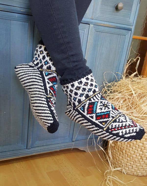Hand knit wool slipper socks with traditional Bosnian pattern worn indoors