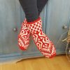 Artisan wool slipper socks in red and white worn indoors