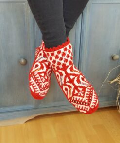 Artisan wool slipper socks in red and white worn indoors
