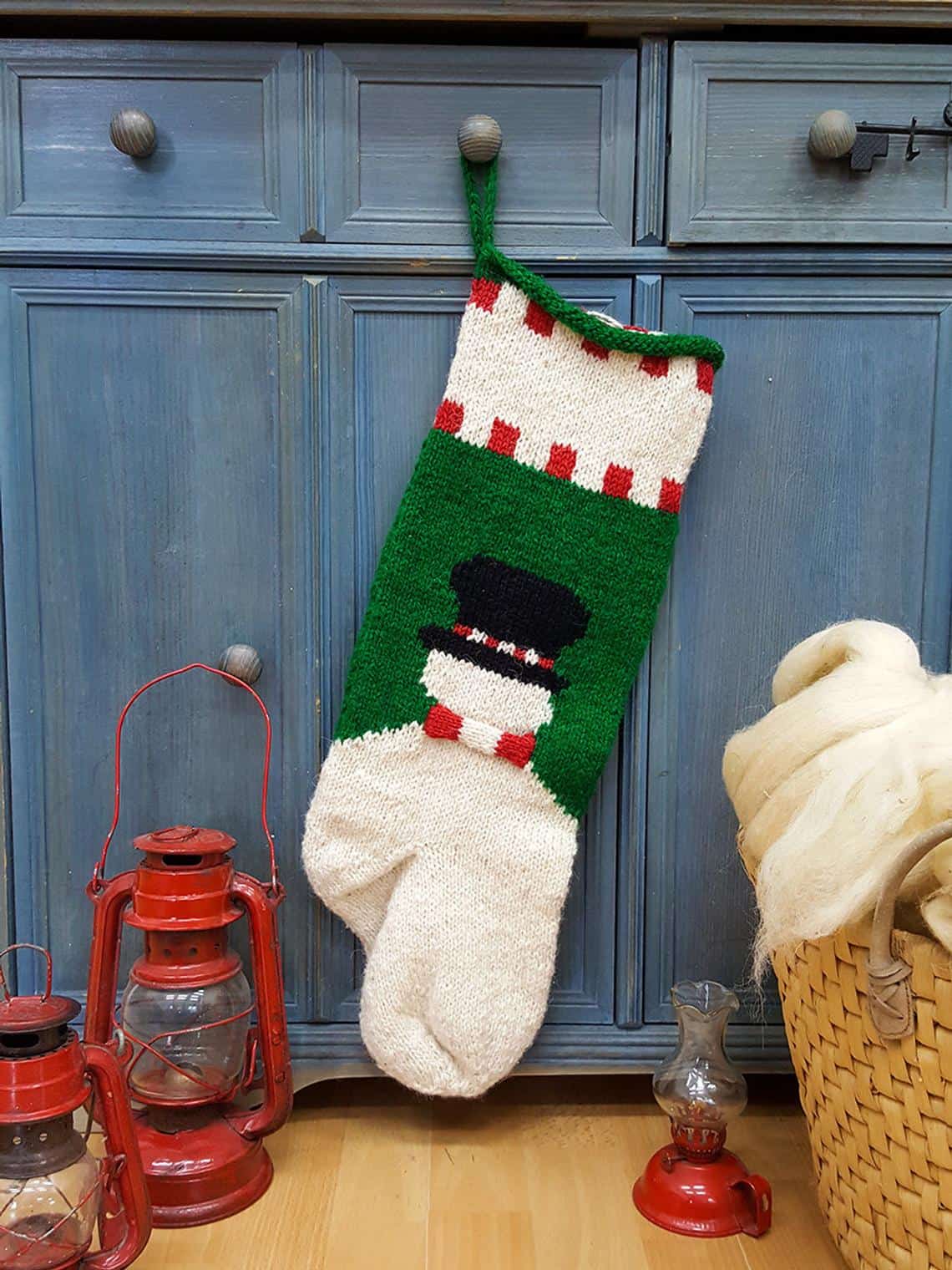 Back side of fair trade holiday stocking featuring customizable name embroidery above a cheerful snowman.