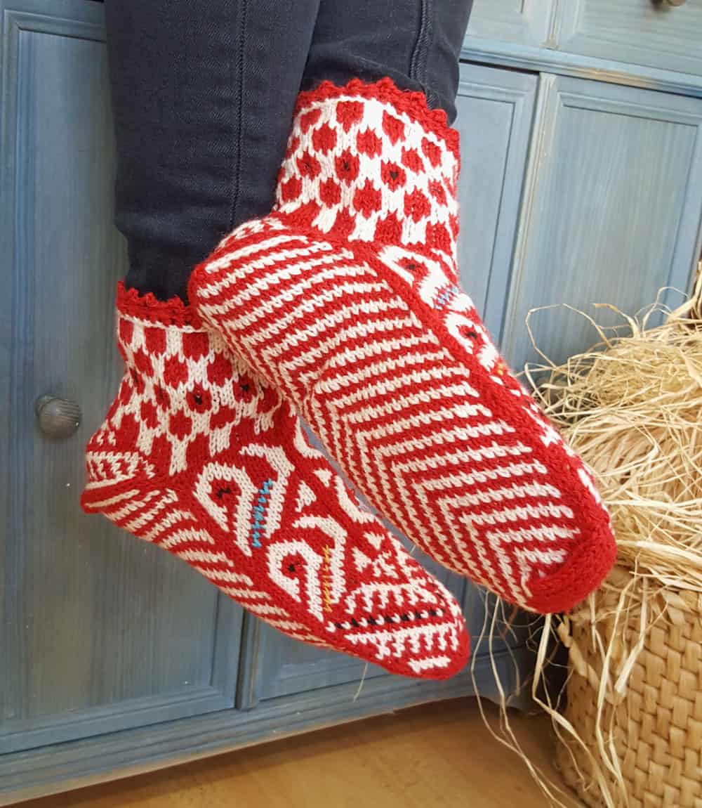 Hand knit red and white wool slipper socks with Bosnian pattern