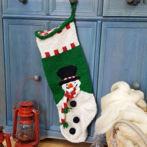Fair-trade handmade holiday stocking featuring a smiling snowman with scarf and top hat.