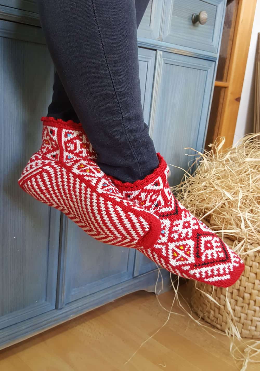 Artisan's handmade wool slippers with red and white design