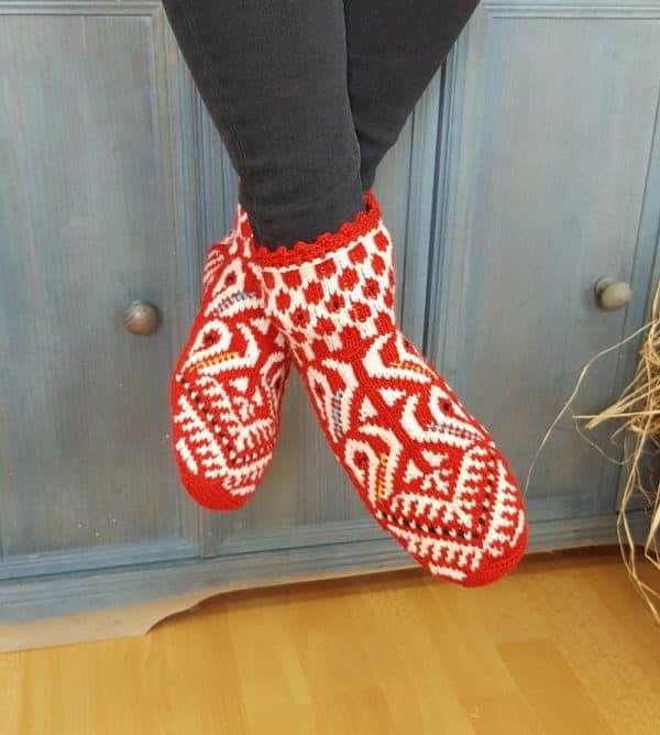 Artisan wool slipper socks in red and white worn indoors