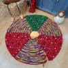 Hand-knitted fair-trade Christmas tree skirt with colorful circular stripes. Have one of the sustainable Christmas home decor items
