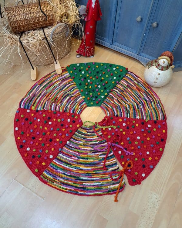 Hand-knitted fair-trade Christmas tree skirt with colorful circular stripes. Have one of the sustainable Christmas home decor items
