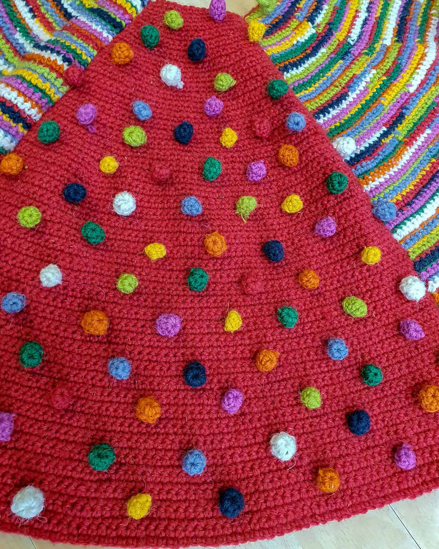 Artisan-made Christmas tree skirt featuring vibrant patterns in festive color pom-poms. It is a sustainable Christmas home decor by all means.