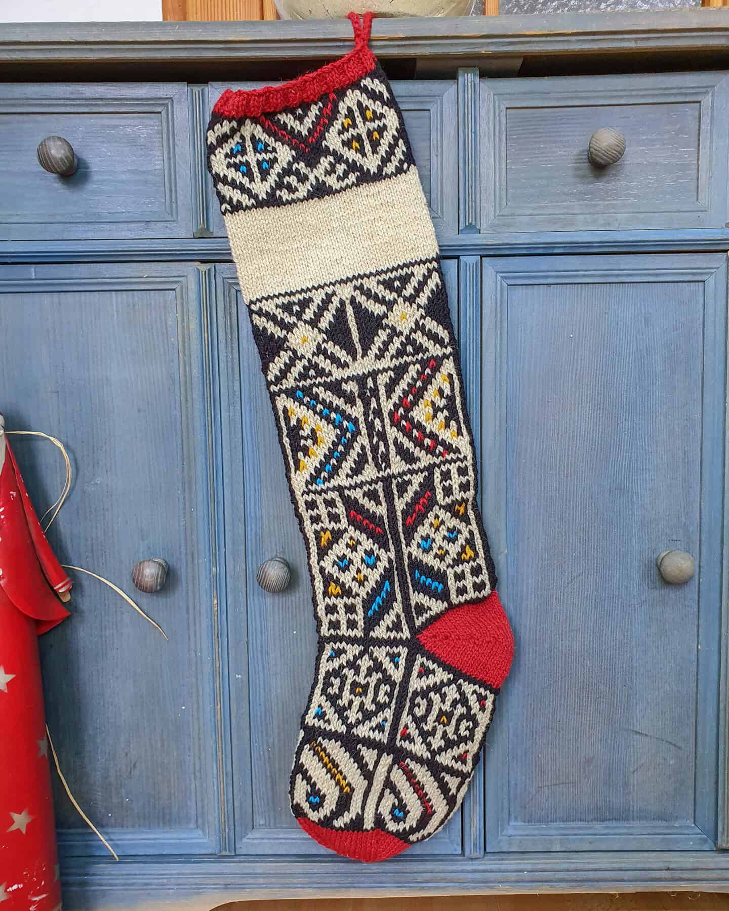 Fair-trade jacquard pattern Christmas stocking with customizable name and red accents. Make your holiday home decor unique
