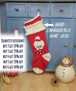 Hand-knitted red and cream Christmas stocking with Mrs. Claus design.