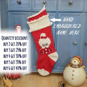 Hand-knitted red and cream Christmas stocking with Mrs. Claus design.