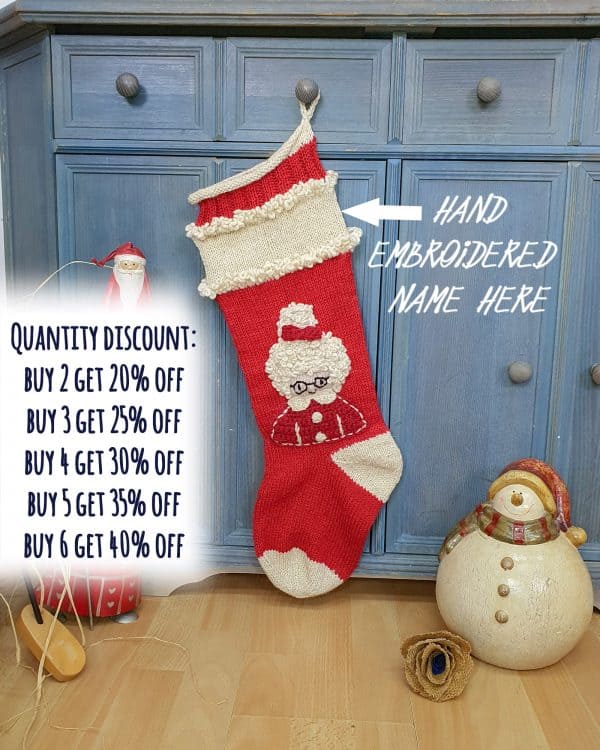 Hand-knitted red and cream Christmas stocking with Mrs. Claus design.