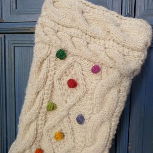 Fair‑trade handmade Bosnian cable‑knit Christmas stocking with multicolored pom-pons