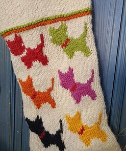 Close-up of handmade Bosnian holiday stocking with colorful knitted dog silhouettes, crafted from natural wool by BHcrafts artisans