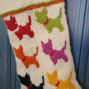 Close-up of handmade Bosnian holiday stocking with colorful knitted dog silhouettes, crafted from natural wool by BHcrafts artisans