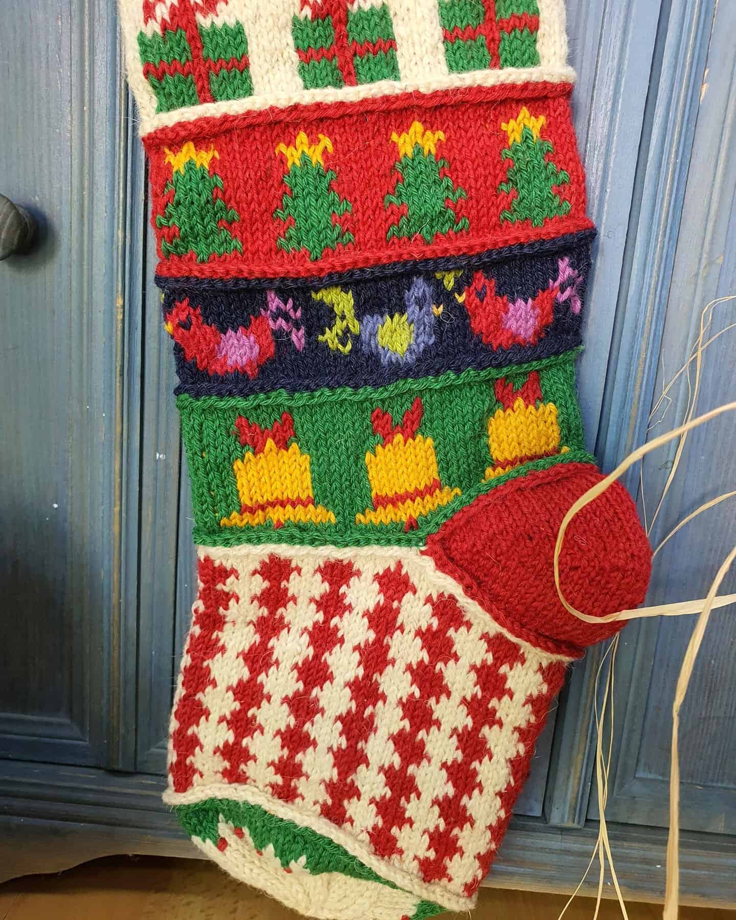 Close-up of heel section of a personalized hand-knitted Christmas stocking.