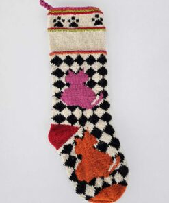 Hand-knitted checker-pattern Christmas stocking with pink and orange cat motifs.