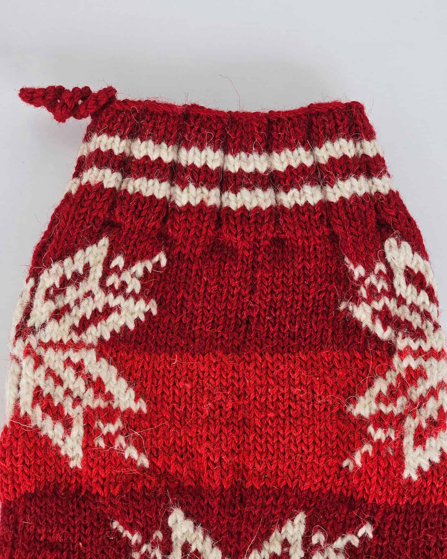 Handmade Christmas stocking with Fair Isle snowflake design in red and cream yarn.