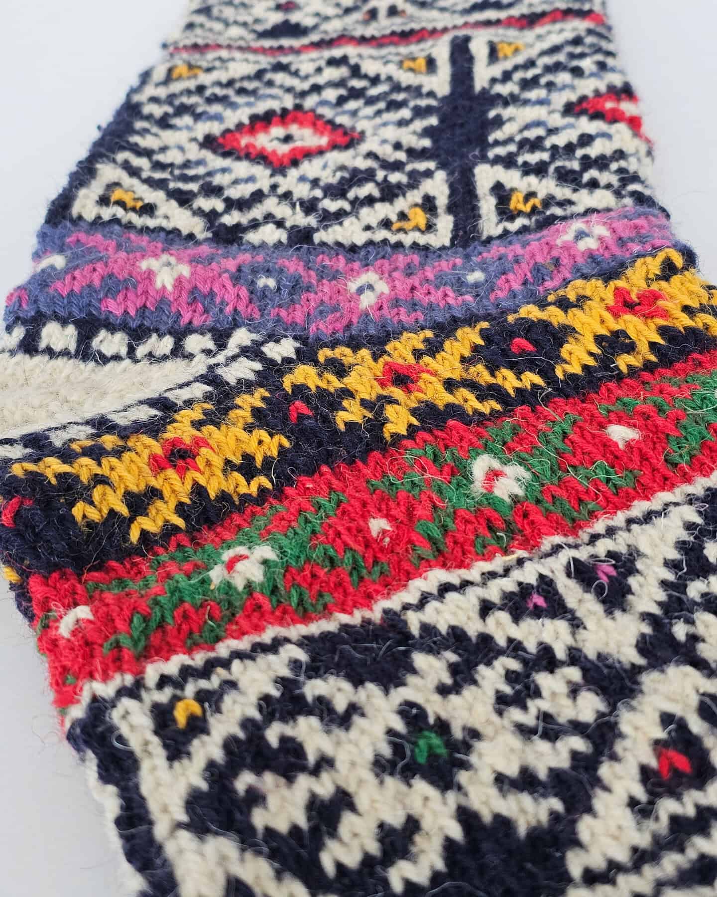 Close-up of personalized navy Christmas tree stocking handmade pattern as perfect choice for holiday decoration.