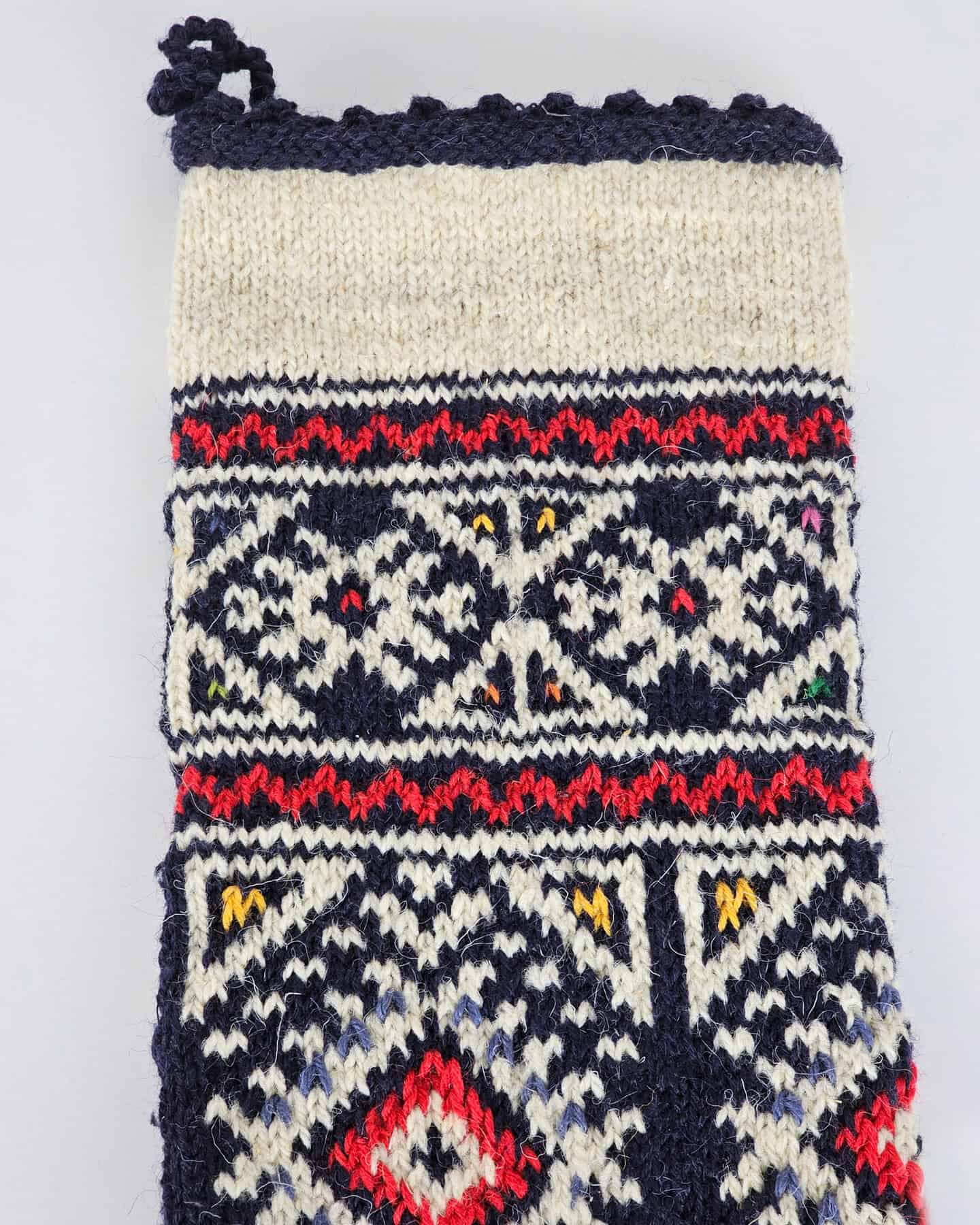 Close-up of top part of the navy Christmas stocking where free personalized embroidery can be placed.