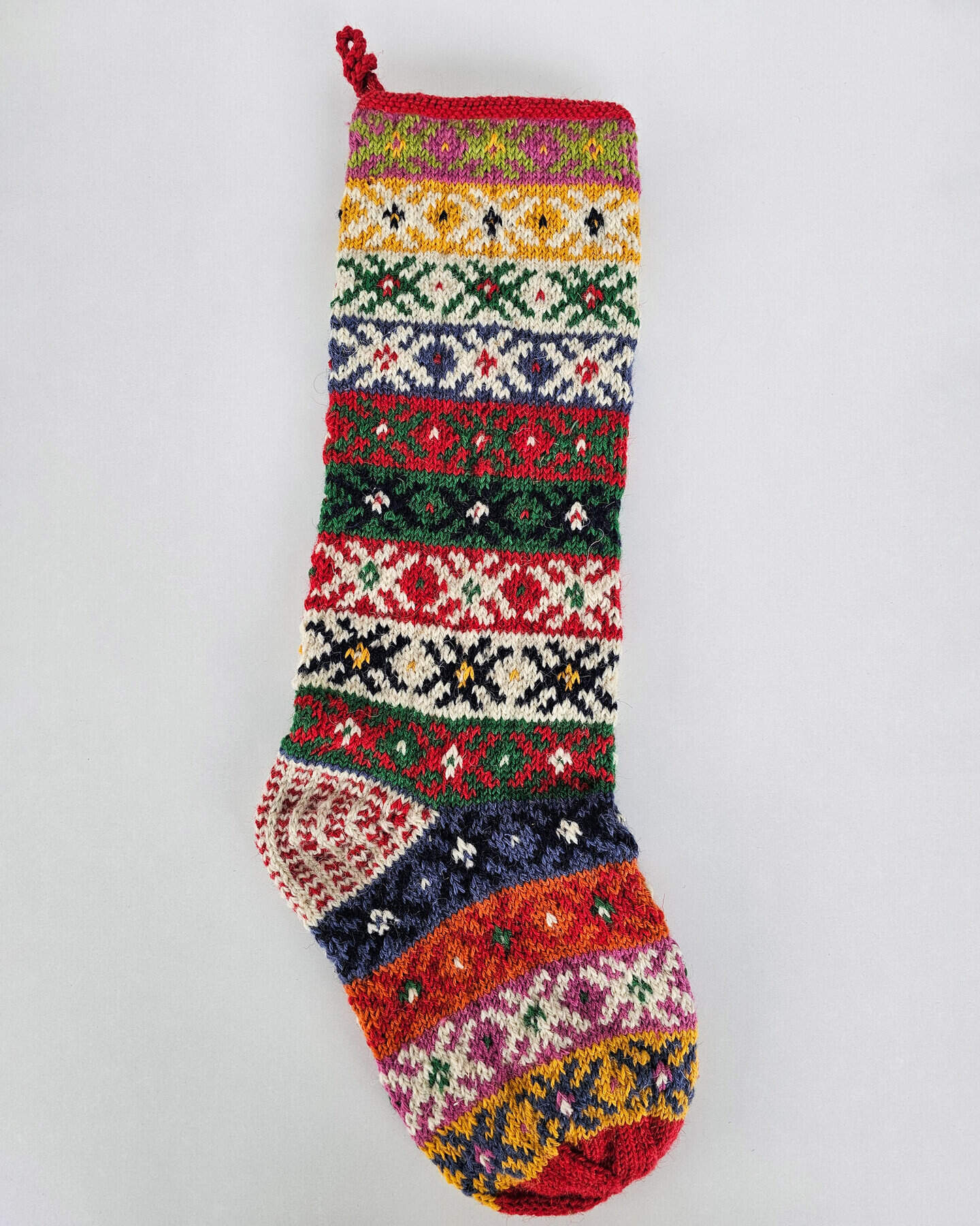 Hand-knitted Christmas stocking with traditional Bosnian slipper sock motif