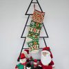 Christmas stocking with traditional pattern hanging on Christmas tree shape