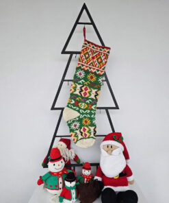 Christmas stocking with traditional pattern hanging on Christmas tree shape