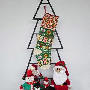 Christmas stocking with traditional pattern hanging on Christmas tree shape