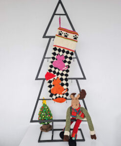 Checkerboard Christmas stocking featuring stylized cats in pink and orange on cream and black background.
