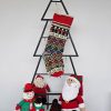Personalized knitted Christmas stocking featuring floral and traditional patterns in red, green, and yellow with a Custom Name.