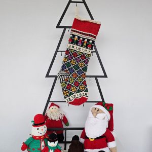 Personalized knitted Christmas stocking featuring floral and traditional patterns in red, green, and yellow with a Custom Name.