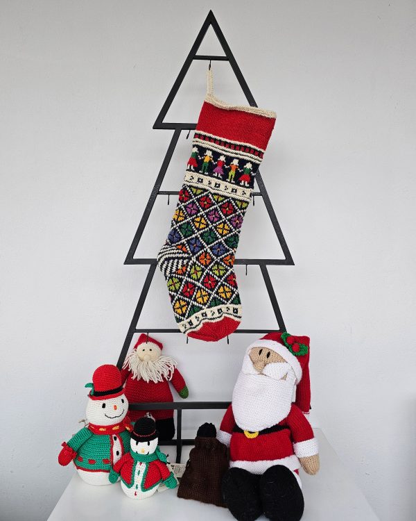 Personalized knitted Christmas stocking featuring floral and traditional patterns in red, green, and yellow with a Custom Name.