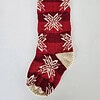 Hand-knitted red Christmas stocking with timeless snowflake pattern