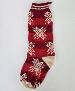 Hand-knitted red Christmas stocking with timeless snowflake pattern