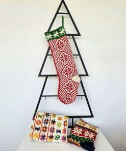 Handmade traditional Christmas stocking displayed with holiday decorations.